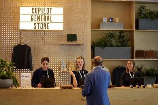 A 'Copilot General Store' counter staffed by three people, a visitor being served.