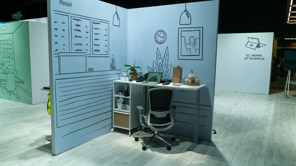 An illustrated retail vignette built as a set - line-drawn shelving and signage around a real desk and chair.