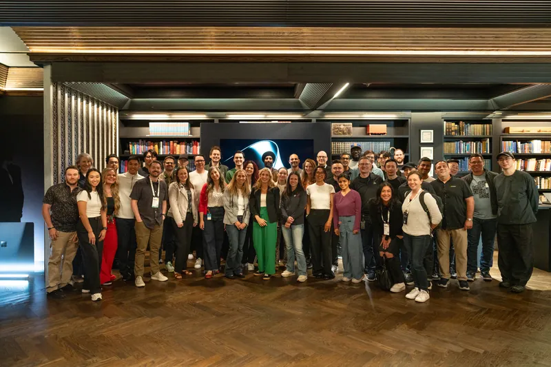The full project team and guests gathered for a group photograph in the timber-lined library lounge.
