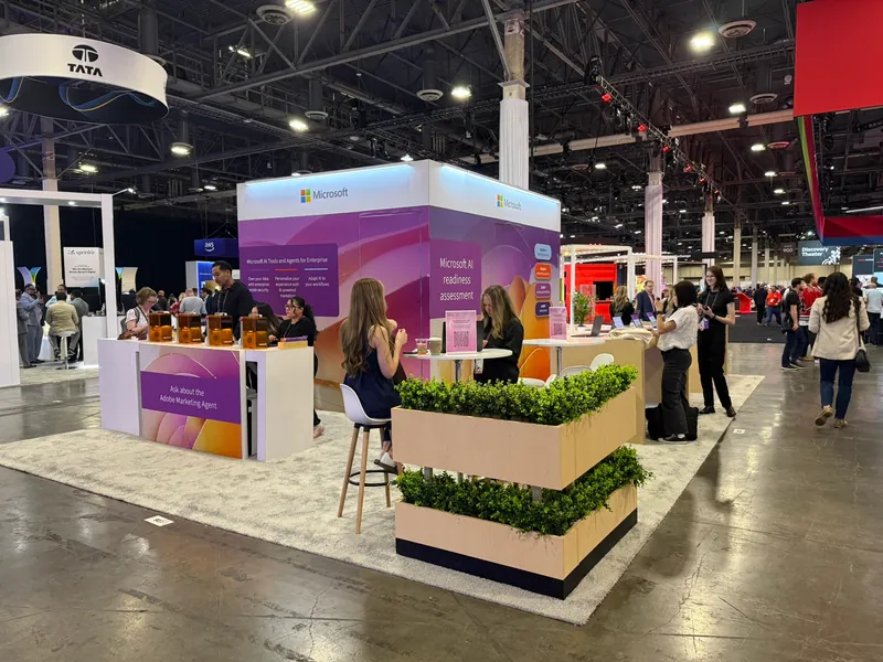 Staff at the stand counter, planting and product laid out along the surface.