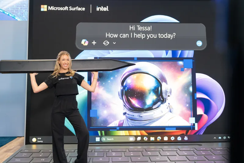 A presenter at the screen wall as the Copilot orb fills the display behind her.