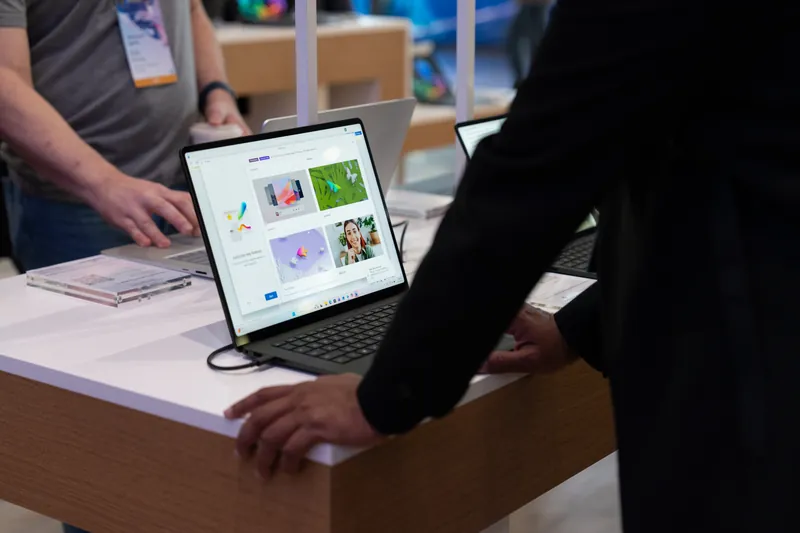 Hands on a laptop at one of the hands-on demo stations.