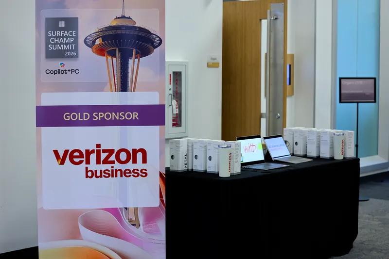 The Surface Champ Summit banner beside the entrance, Verizon Business named as gold sponsor.